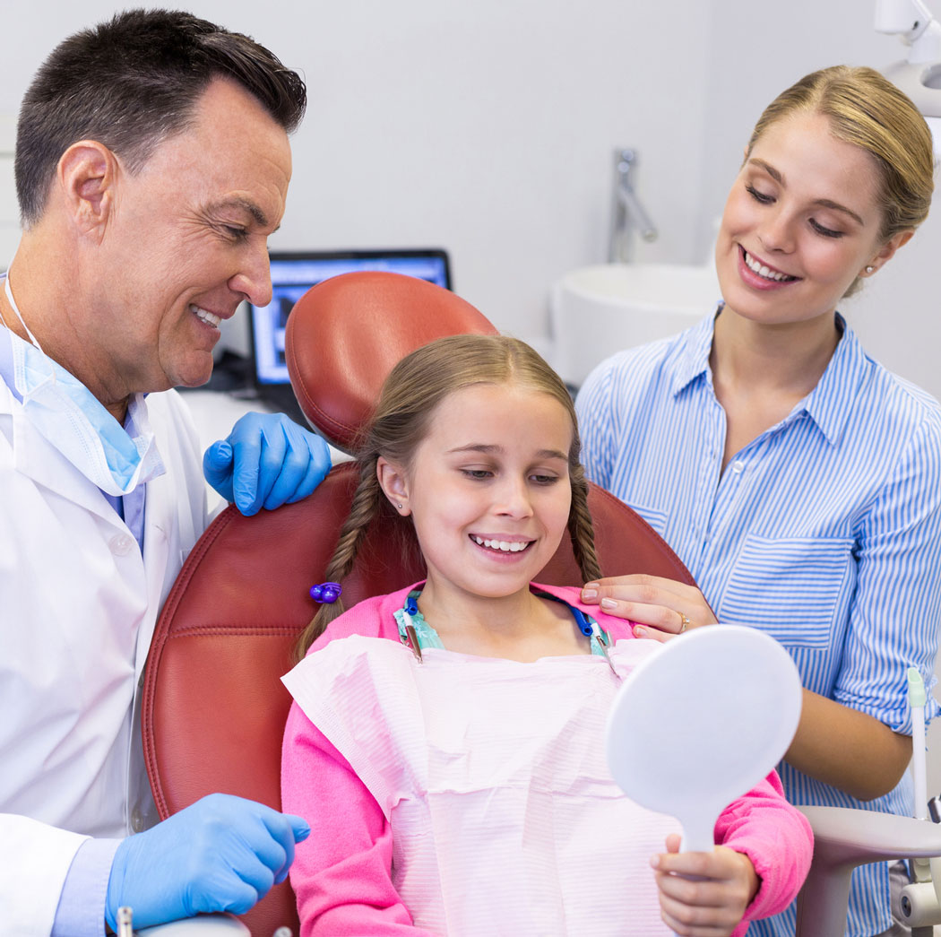 Young patient looking at mirror in dental clinic